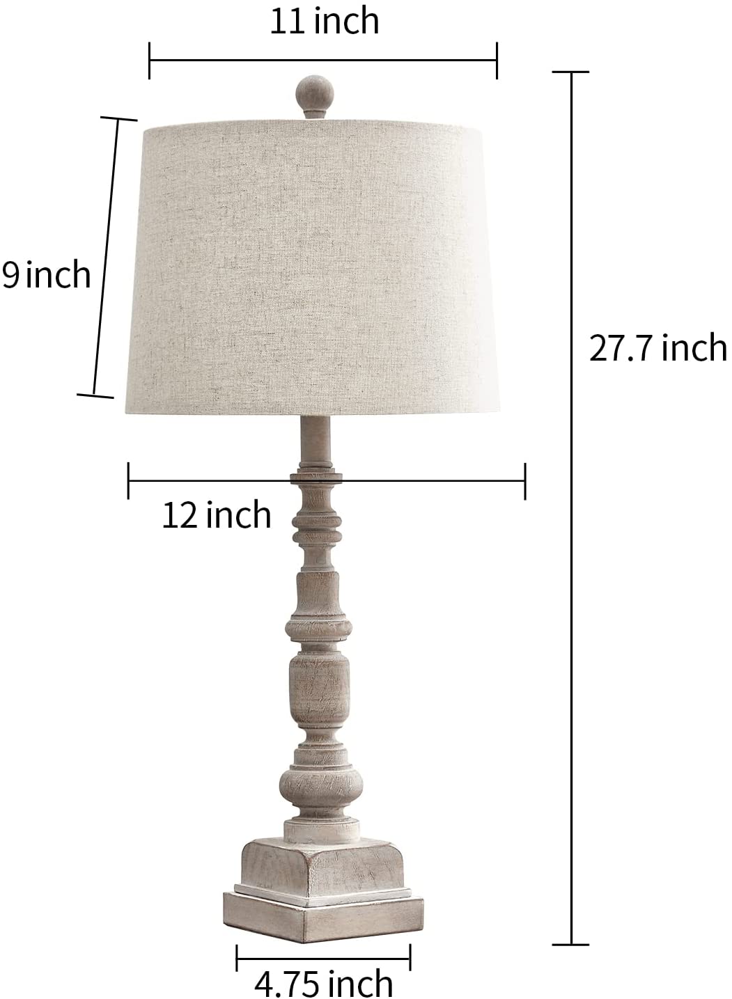A traditional table lamp featuring a distressed, turned-wood candlestick base and a neutral beige fabric drum shade