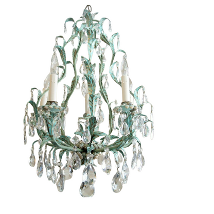 A vintage teal and gold leaf chandelier adorned with hanging crystal teardrops.